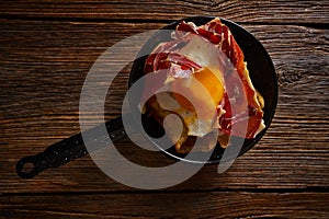 Tapas huevos rotos broken eggs with ham photo