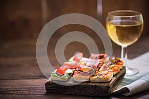 Tapas and wine served on wooden board