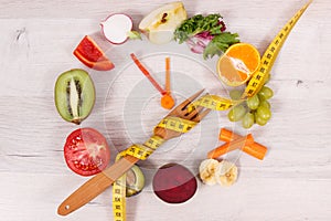 Tape measue with fruits and vegetables in shape of clock showing time to healthy eating and slimming