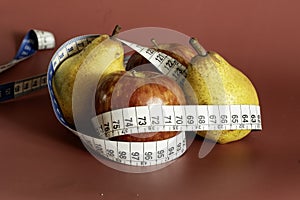 Tape measure and apple symbolizing diet and obesity