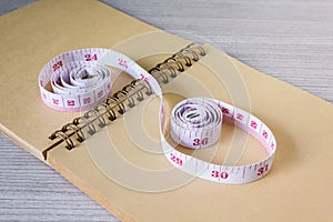 Tape measure on blank note paper or memo note for concept of we