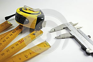 Tape measure caliper and extendable ruler