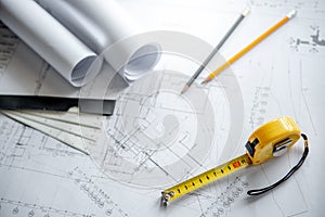 Tape measure and drawing tools on blueprint