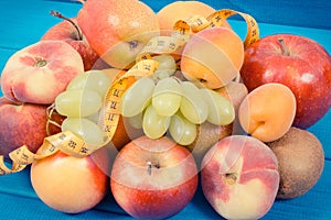 Tape measure with fresh natural fruits containing nutritious vitamins for healthy lifestyles