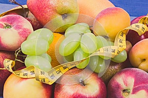Tape measure with fresh natural fruits containing nutritious vitamins for healthy lifestyles