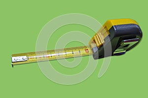 Tape measure on green background