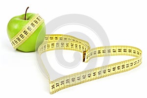 Tape measure heart shape and green apple