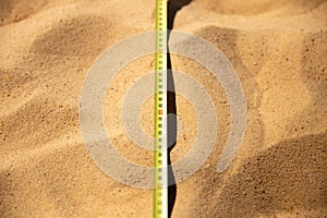 Tape measure lying on the sand, long jump competitions. Length measurement, dimensions of the sports field