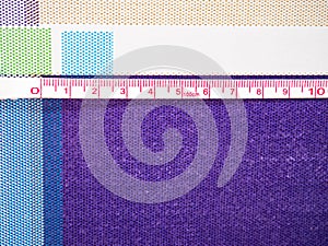 Tape measure marking ten centimeters on a rubber tablecloth