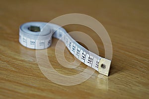 Tape measure measuring length in centimeters and meters, frequently used for measuring the perimeter of human body during the die