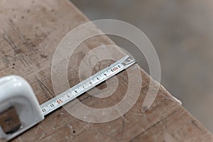 Tape measure on work table in the carpentry