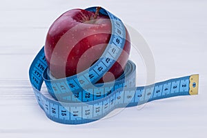 Tape measure wrapped around fresh apple.