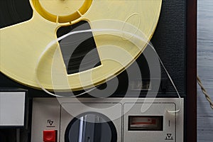 The tape on the reel of the magnetic tape recorder, close-up of buttons