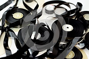 Tape ribbons with the supply and take up reels of VHS video cassette tapes used on old video players and recorders, retro style