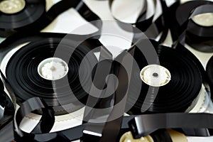 Tape ribbons with the supply and take up reels of VHS video cassette tapes used on old video players and recorders, retro style