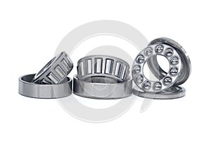 Tapered roller and thrust ball bearings isolated on white