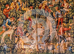 A tapestry of hunters hunting a unicorn photo