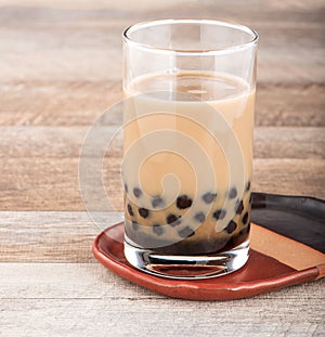 Tapioca Pearl , Bubble topping for tea or other beverage, in a cup, place on wooden table. Copy space