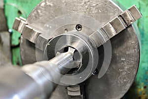 Tapping on a lathe, the tap cuts the hole by applying pressure from the tailstock
