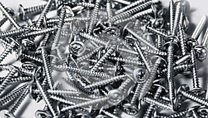 Tapping screws made od steel, metal screw, iron screw, chrome screw, as a background, wood