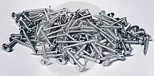 Tapping screws made od steel, metal screw, iron screw, chrome screw, as a background, wood