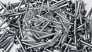 Tapping screws made od steel, metal screw, iron screw, chrome screw, as a background, wood photo