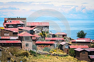 Taquile island houses and Titicaca lake photo