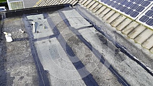 Tar foil roof repair: new patches installed to prevent further leaking from the roof.