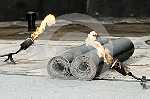 Tar roofing felt roll and blowpipe photo