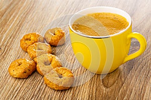 Tarallini, black coffee in yellow cup on wooden table