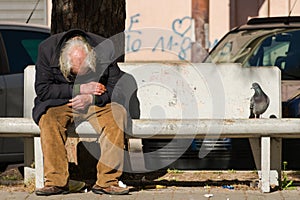 Taranto, Apulia / Italy - 03/23/2019 : A lost homeless old man depressed on bench