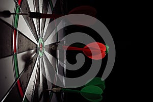 Target with arrow in the center on a black background