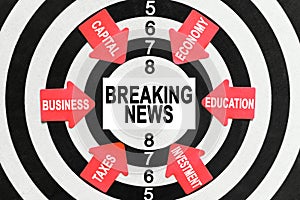 On the target, arrows with business lettering point to the center on a business card with the inscription - BREAKING NEWS