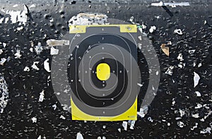 Target centered on a black background with bullet holes for shooting sports with rifles and handguns.