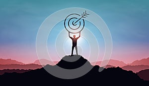 Targeting the business goal and achievement success concept. Businessman standing on top of mountain and holding target board