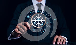 Targeting business and investment concept. Businessman holding a magnifying glass looking target with icons. Digital marketing