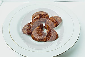 Taripang cake on a white plate on a plain white table