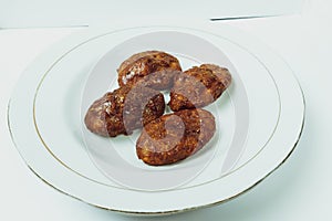 Taripang cake on a white plate on a plain white table