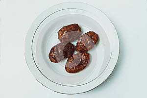 Taripang cake on a white plate on a plain white table