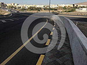 Tarmac or asphalt Road highways ways With concrete barrier along with interlocking tiles and precast concrete stones painted as