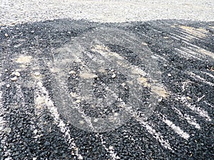 Tarmac on a roadside with sand