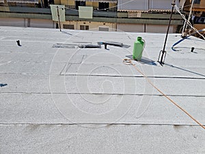 tarmac terrace insulation waterproof instalation worke working on the roof of a building