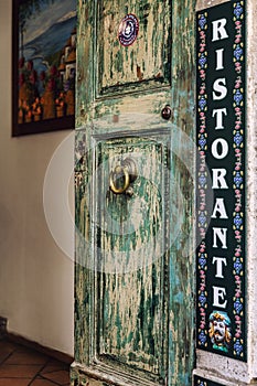 Tarmina, Italy, 08/30/2016: Old vintage entrance door to a restaurant