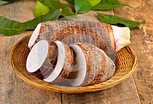 Taro root on wooden background photo