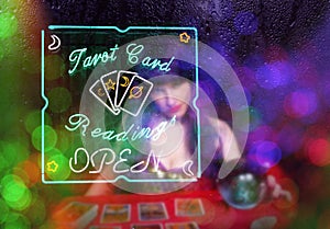 Tarot Card Readings Neon Sign in Window with Psychic Tarot Card Reader in background