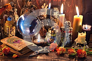 Tarot cards, burning candles, witch magic bottles and crystal ball