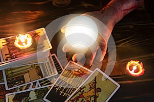Tarot cards and crystal ball reading psychic by zombie hand candlelight well as divination