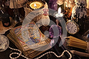 The tarot cards with crystal, candles and magic objects