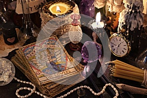 The tarot cards with crystal, candles and magic objects photo