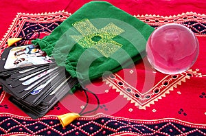 Tarot cards in green pouch and crystal ball
